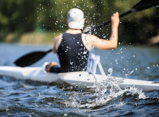 Athlete rowing kayak
