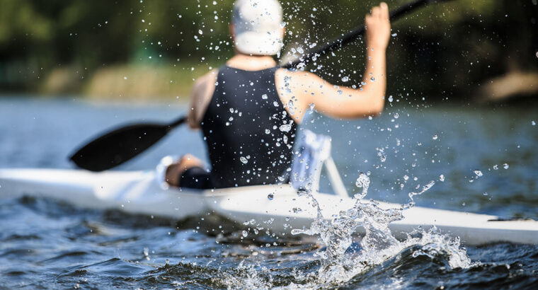 Athlete rowing kayak
