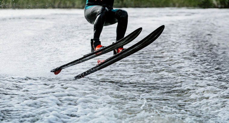 Man waterskiing on lake behind