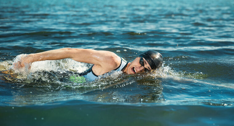 Professional triathlete swimming in river